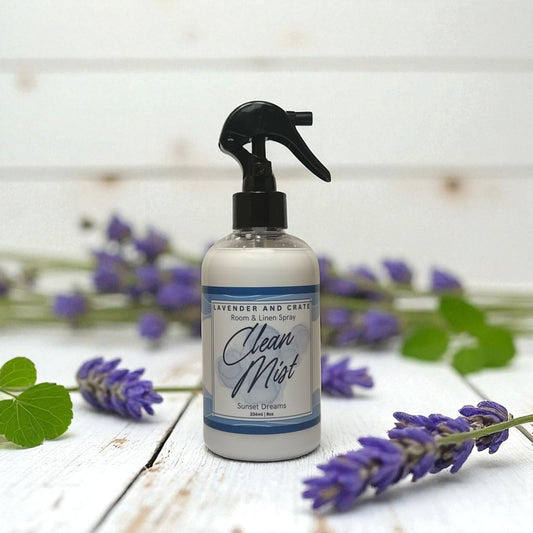 Spray bottle labeled 'Clean Mist' with lavender flowers on a wooden surface