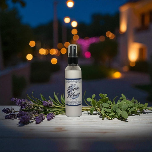 Spray bottle labeled 'Dream Weaver' with lavender and greenery on a wooden surface at night.